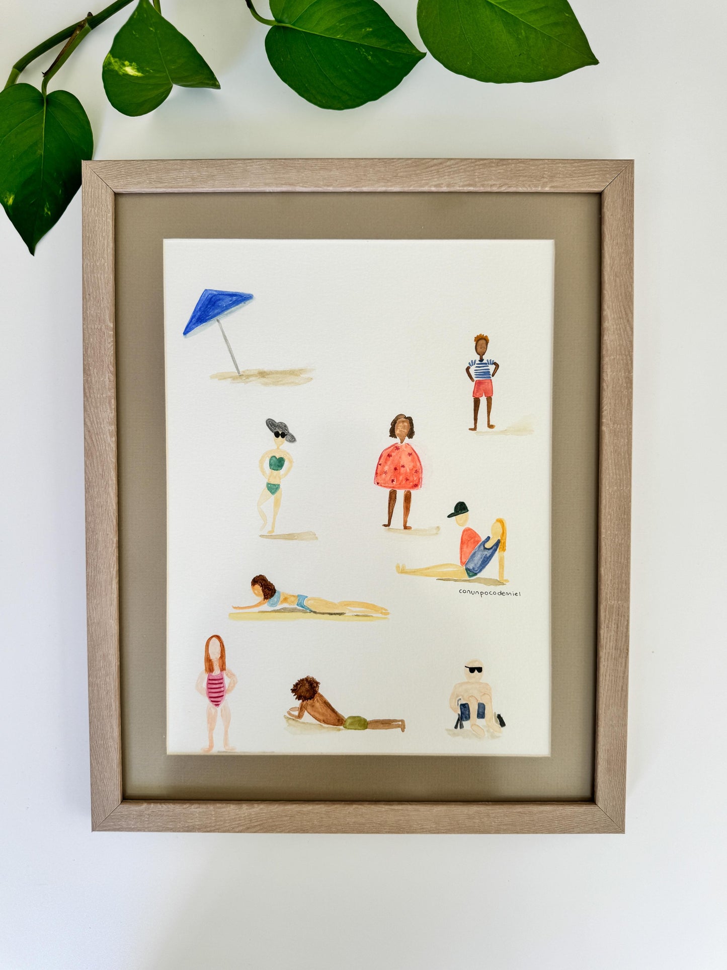 Acuarela enmarcada con dibujo de personas en la playa