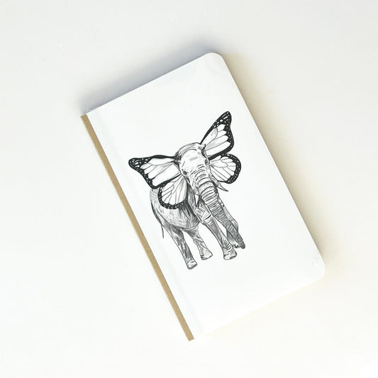 Foto de libreta con dibujo de un elefante con orejas de mariposa